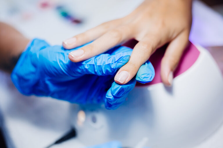 beautiful female hands finger nail treatment making process professional nail file drill action beauty hand care concept